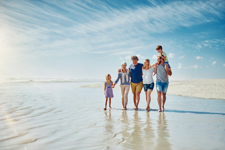Shot of a happy family going for a walk together at the beach