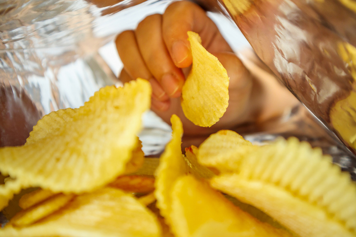 hand in a bag of chips