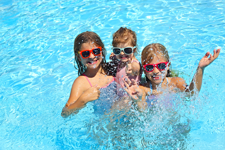 Three cute girls playing in myrtle beach oceanfront swimming pool.