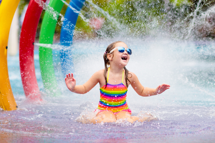 little girl playing in silly sprayers at myrtle beach resort with waterpark