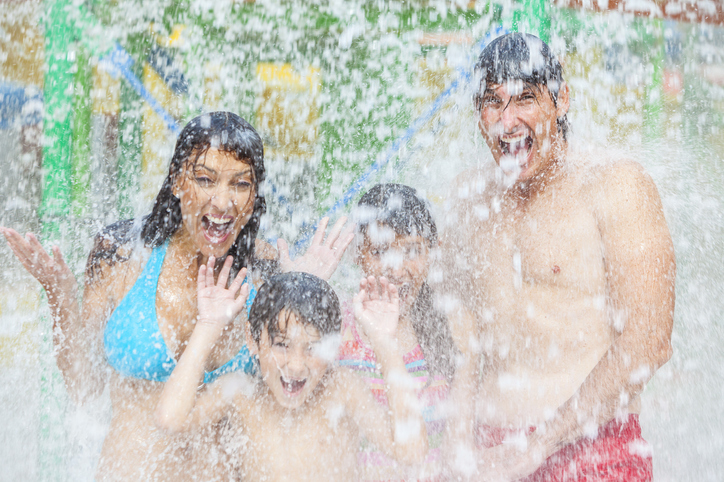 family having fun with umbrella rain makers at myrtle beach resort with water park coral beach